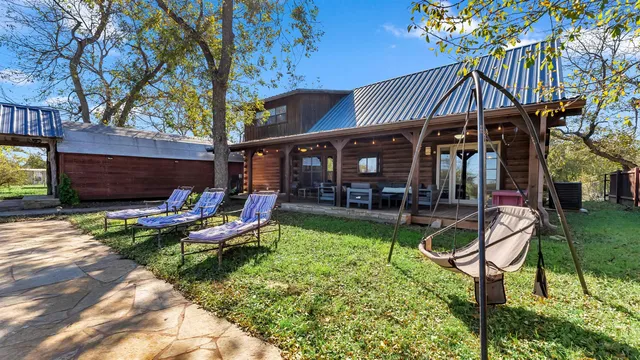 a view of a house with backyard porch and sitting area