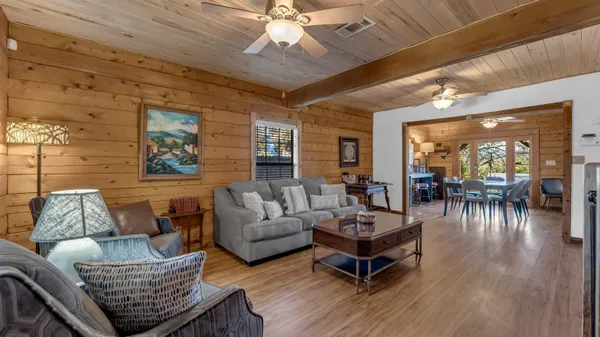 a living room with furniture and wooden floor