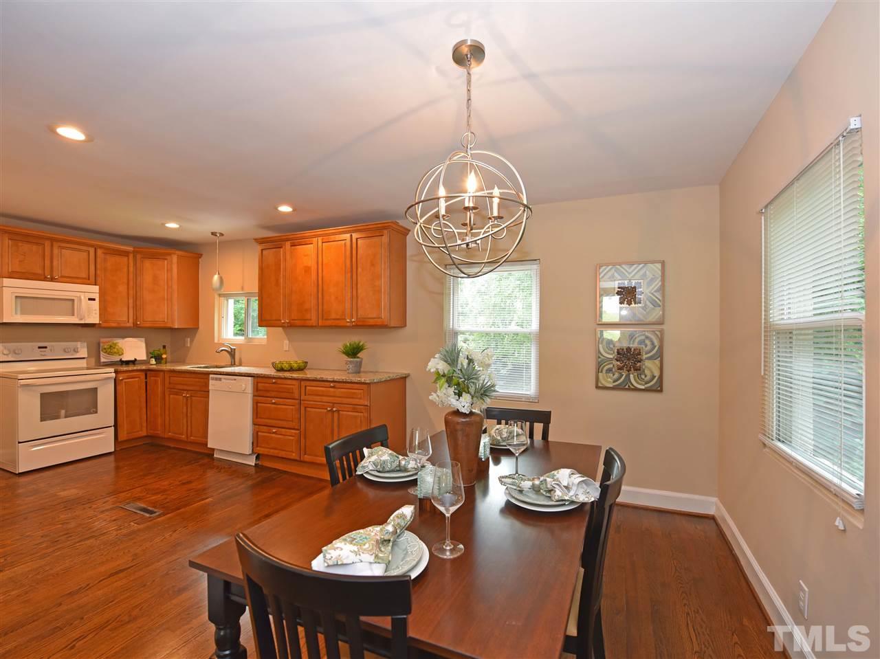 726 South State Street Raleigh, NC 27601 - Photo 12 of 25 a open dining room with stainless steel appliances kitchen island furniture and wooden floor