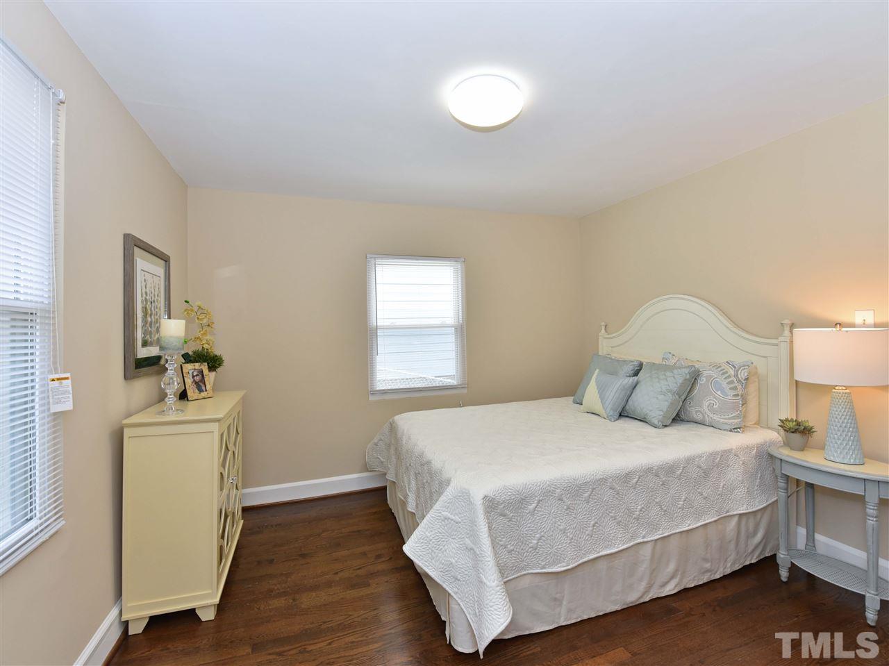 726 South State Street Raleigh, NC 27601 - Photo 13 of 25 a bedroom with a bed and wooden floor