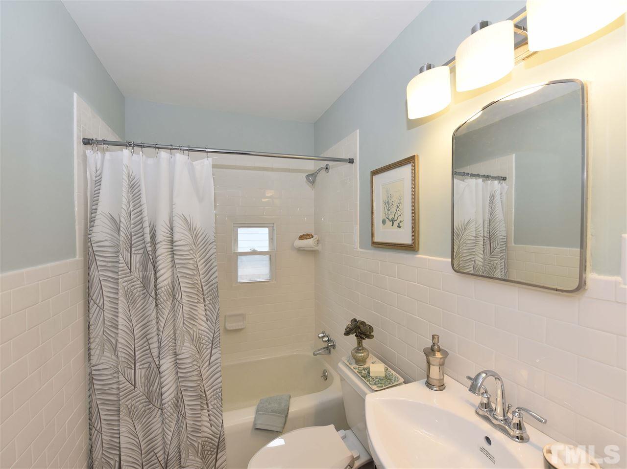 726 South State Street Raleigh, NC 27601 - Photo 14 of 25 a bathroom with a sink mirror and a toilet