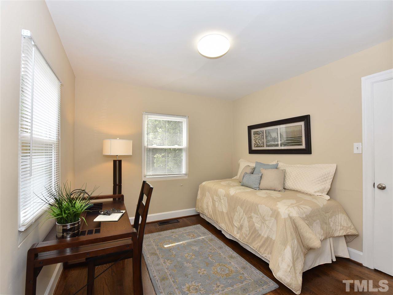 726 South State Street Raleigh, NC 27601 - Photo 15 of 25 a bedroom with a large bed and a potted plant
