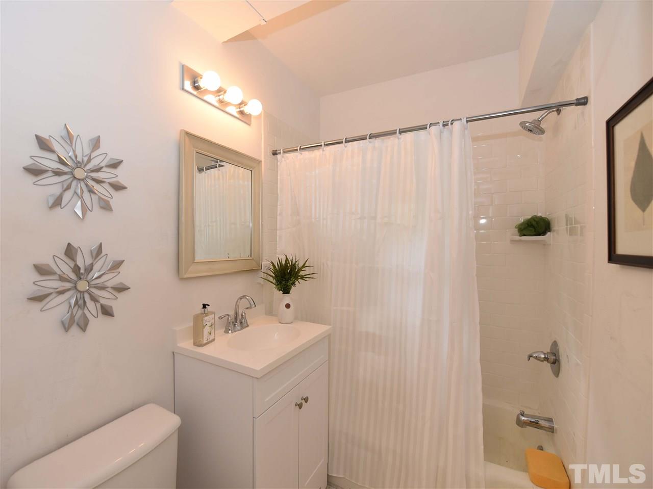 726 South State Street Raleigh, NC 27601 - Photo 17 of 25 a bathroom with a sink a toilet and a mirror