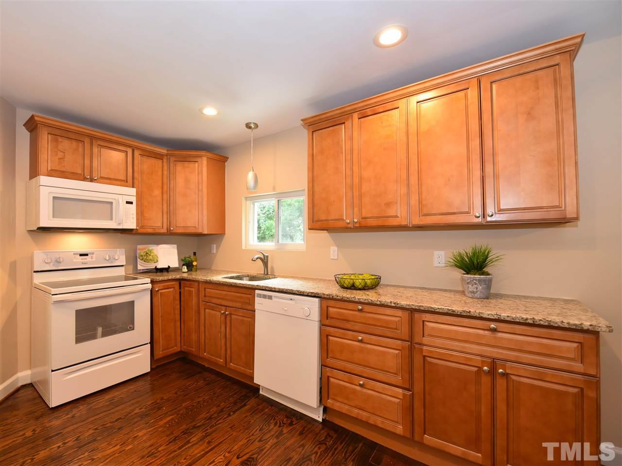 726 South State Street Raleigh, NC 27601 - Photo 10 of 25 a kitchen with stainless steel appliances granite countertop a sink a stove cabinets and wooden floor