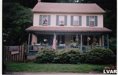 a front view of a house with garden and porch