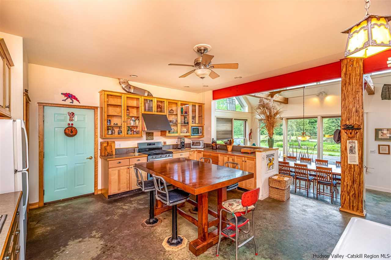 151 Wilhelm Road Saugerties, NY 12477 - Photo 13 of 35 a dining room with furniture a chandelier and a rug