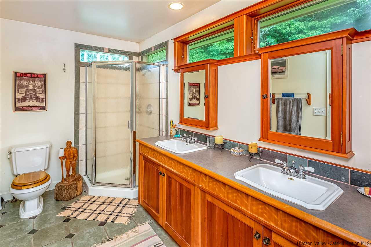 151 Wilhelm Road Saugerties, NY 12477 - Photo 23 of 35 a bathroom with a granite countertop sink mirror vanity and toilet