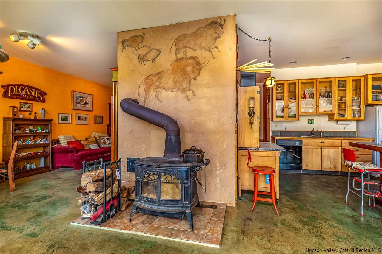 151 Wilhelm Road Saugerties, NY 12477 - Photo 9 of 35 a living room with furniture a rug and a wall painting