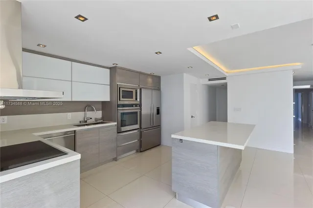 a kitchen with stainless steel appliances a refrigerator and a stove