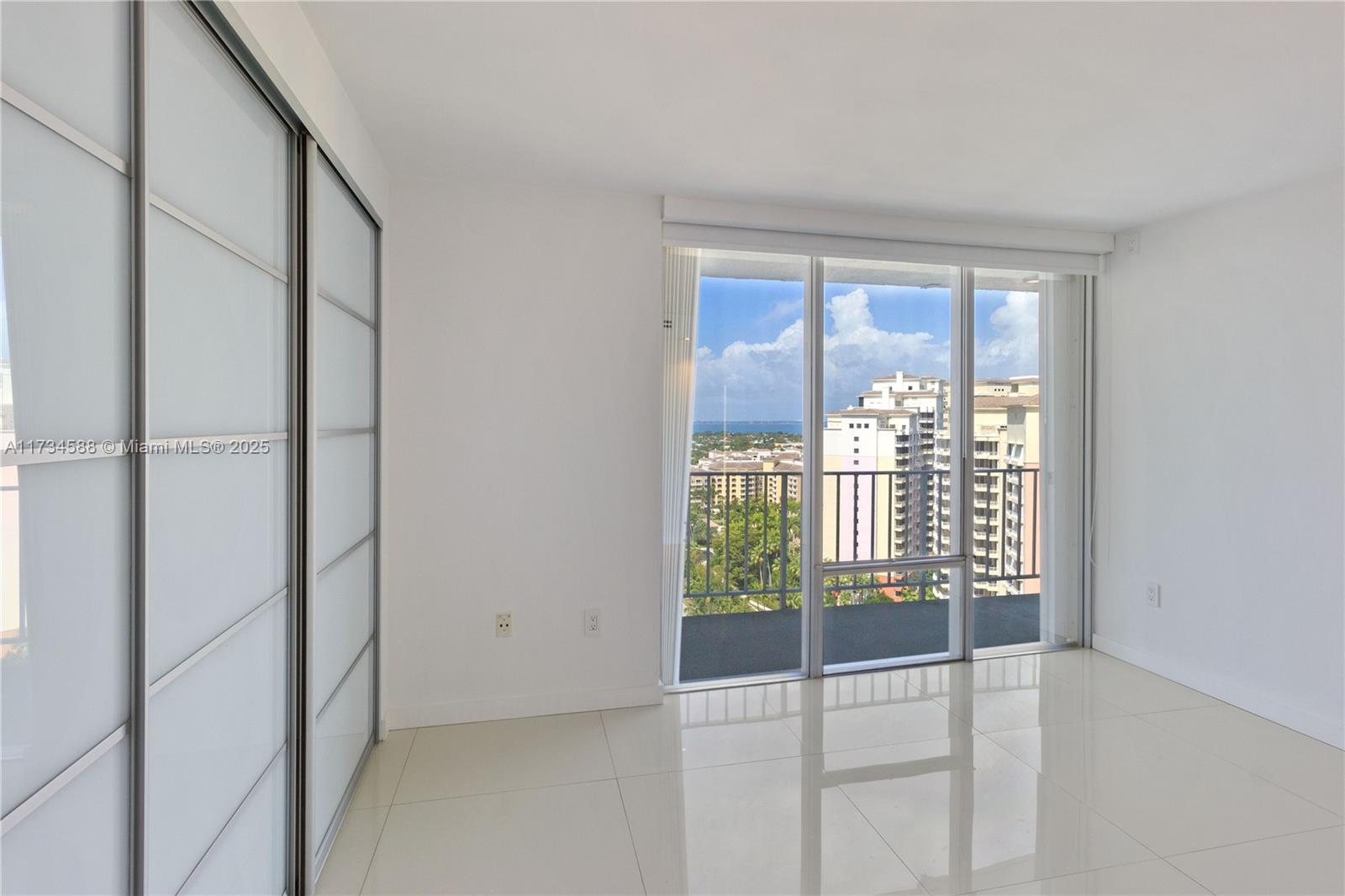 881 Ocean Drive, Unit 18F Key Biscayne, FL 33149 - Photo 8 of 12 an empty room with windows