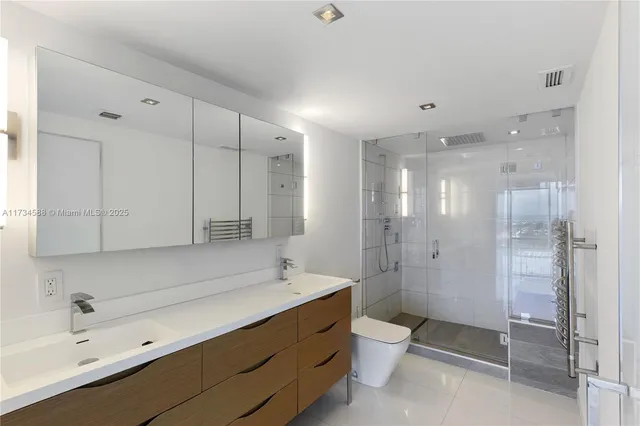 a bathroom with a shower sink and mirror