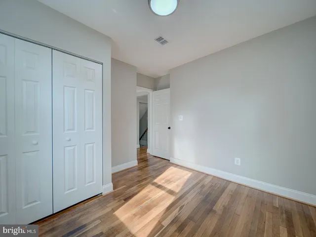 a view of an empty room and wooden floor