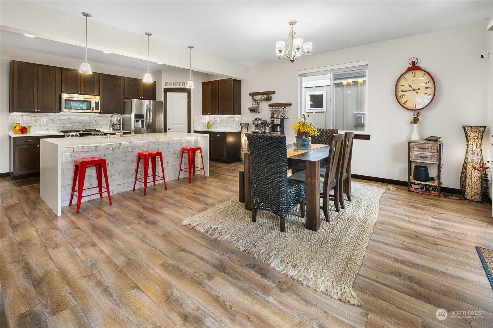 17601 3rd Avenue Southeast Bothell, WA 98012 - Photo 9 of 31 a living room with stainless steel appliances kitchen island granite countertop furniture and a wooden floor