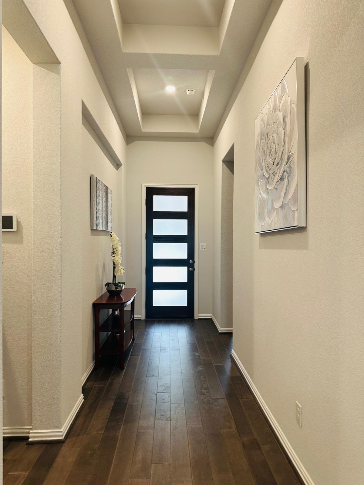 862 Leadtree Loop Buda, TX 78610 - Photo 6 of 40 a view of a hallway with wooden floor and closet
