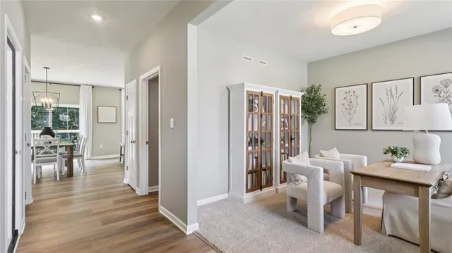 a dining room with furniture and wooden floor