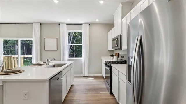 a kitchen with a sink stove and refrigerator