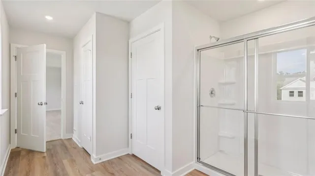 a bathroom with a shower and a glass door