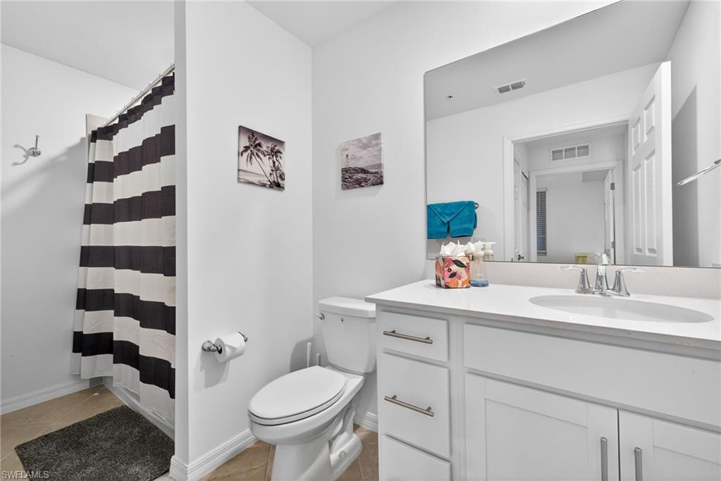 43985 Boardwalk Loop, Unit 2115 Punta Gorda, FL 33982 - Photo 16 of 28 a bathroom with a sink a toilet a shower and a mirror