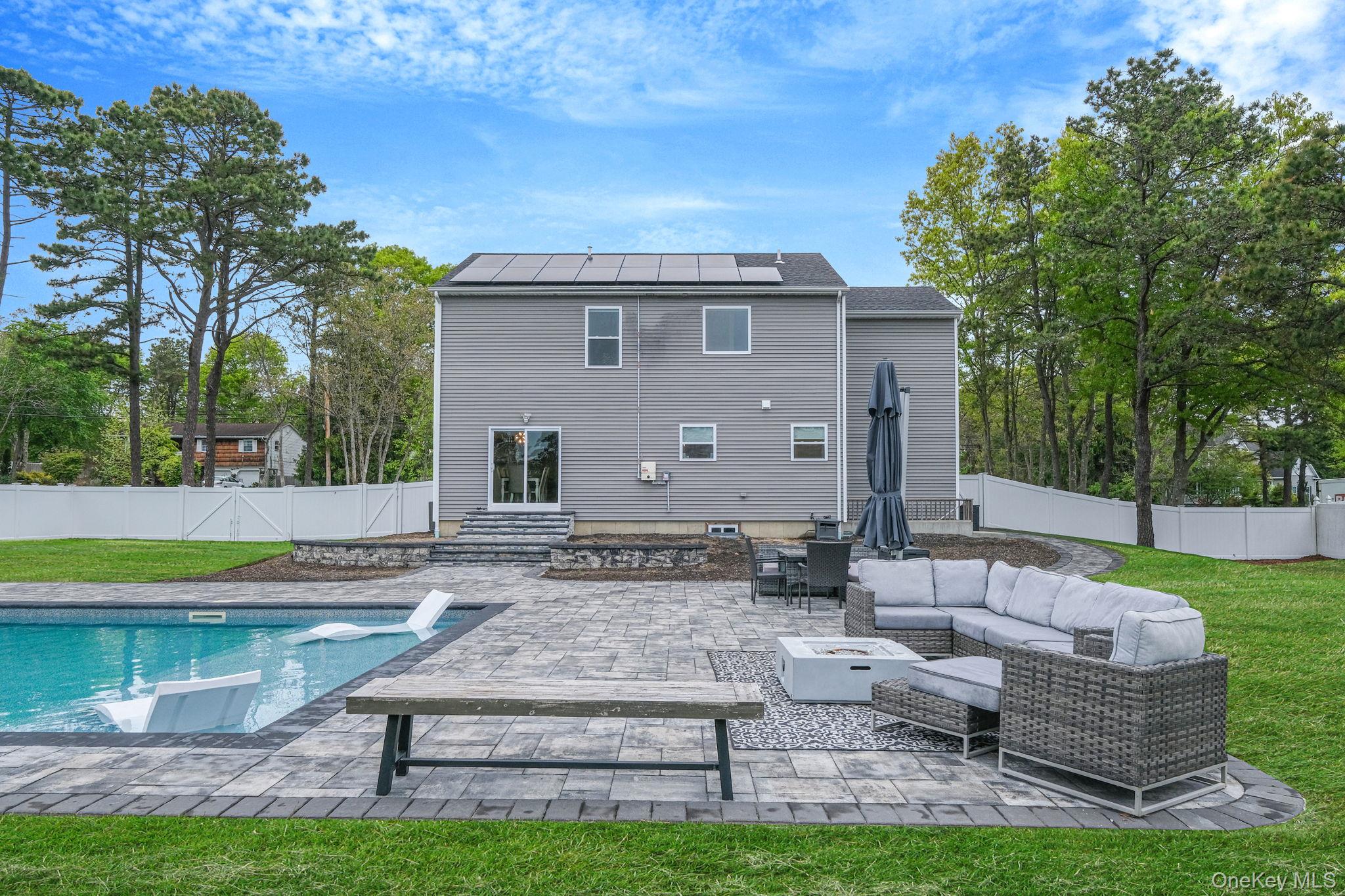 86 Country Road Medford, NY 11763 - Photo 9 of 47 .52 acres with 44’ x 20’ gas-heated Jandy TruGuard mineral in-ground pool with a 10’ sundeck, lounge area, and gorgeous waterfall feature
