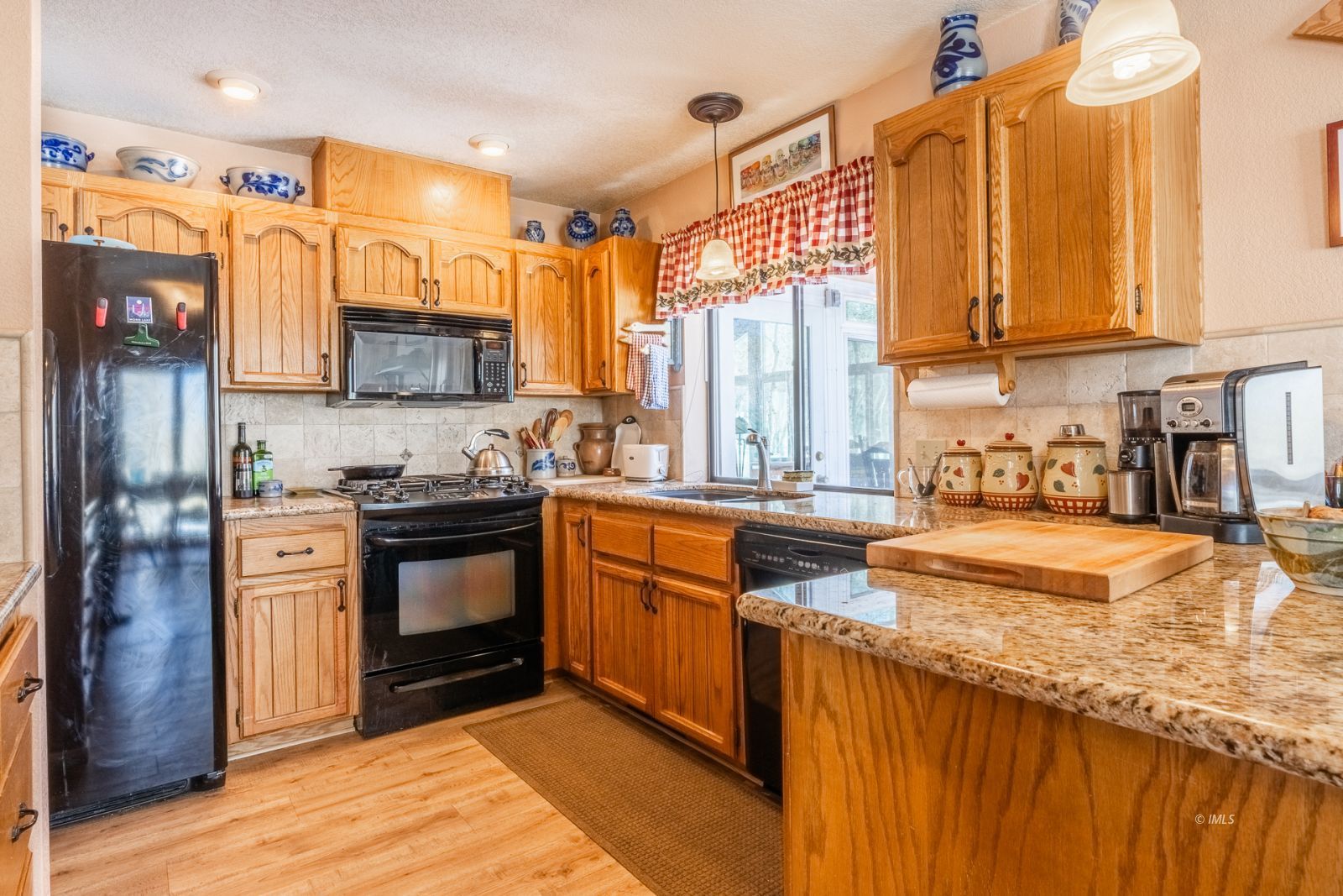 215 Alpine Drive Bishop, CA 93514 - Photo 15 of 33 a kitchen with stainless steel appliances granite countertop a stove a sink and a refrigerator