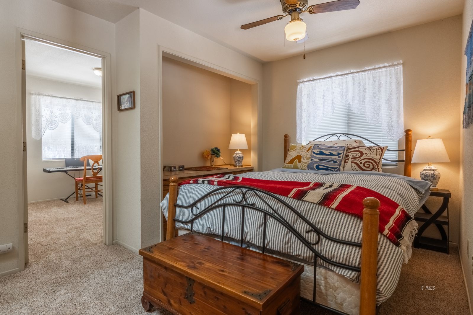 215 Alpine Drive Bishop, CA 93514 - Photo 23 of 33 a bedroom with a bed and a chandelier