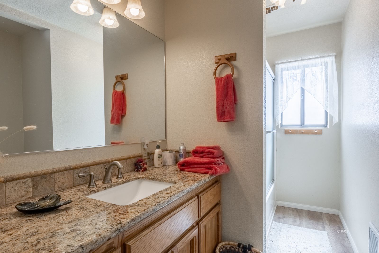 215 Alpine Drive Bishop, CA 93514 - Photo 26 of 33 a bathroom with a granite countertop sink and a mirror