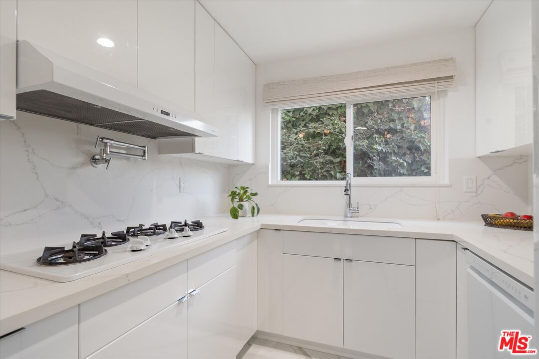 1327 Stanford Street, Unit 3 Santa Monica, CA 90404 - Photo 6 of 12 a kitchen with a sink cabinets and window