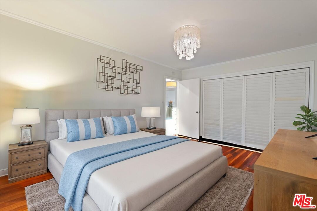 1327 Stanford Street, Unit 3 Santa Monica, CA 90404 - Photo 7 of 12 a bed room with a bed and a chandelier