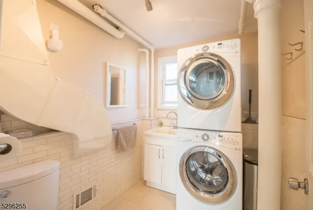 a view of a storage and utility room with washer and dryer