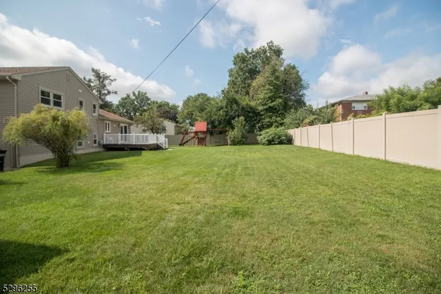a view of a house with a yard and garage