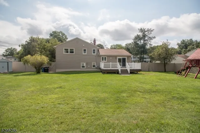 a view of a house with a yard and sitting area