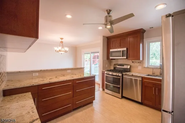 a kitchen with stainless steel appliances granite countertop a sink and stove top oven