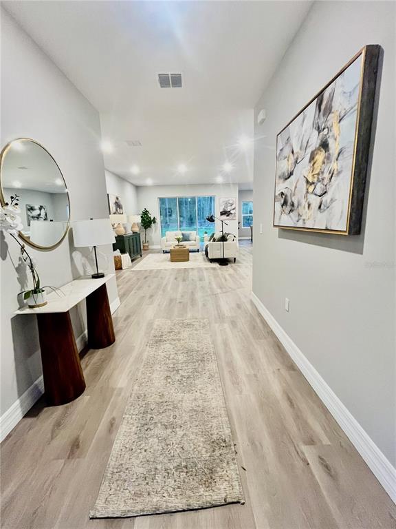 8217 Nightingale Road Brooksville, FL 34613 - Photo 2 of 8 a living room with furniture and a fireplace