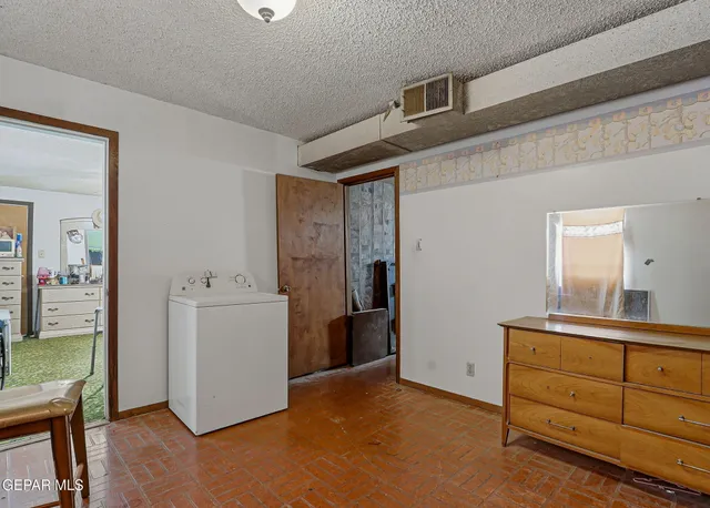 a view of a kitchen with refrigerator and wooden floor
