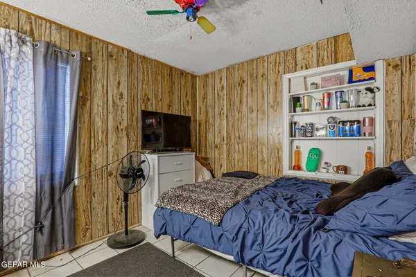 a bedroom with a bed furniture and a flat screen tv