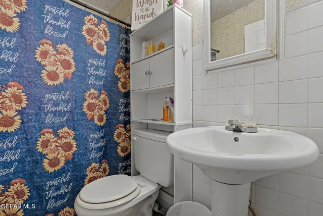 a bathroom with a sink mirror and toilet