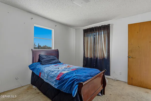 a bedroom with a bed and a window