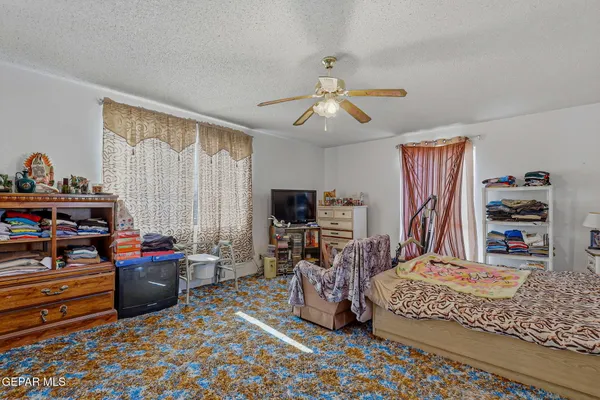 a bedroom with furniture and a flat screen tv
