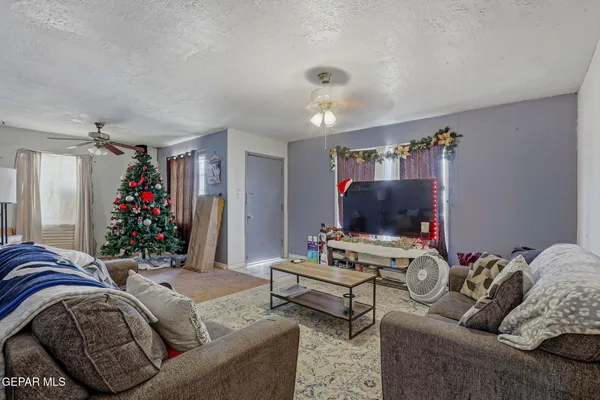 a living room with furniture and a flat screen tv