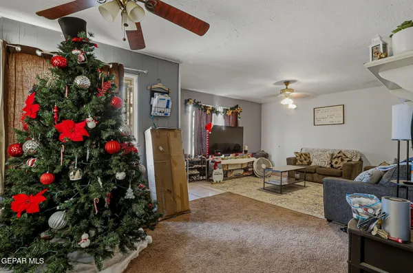 a living room with furniture and flowers