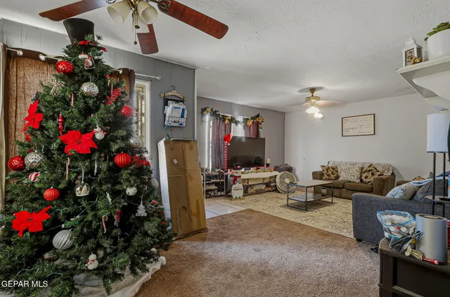 a living room with furniture and flowers