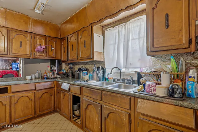 a kitchen with stainless steel appliances granite countertop a sink dishwasher and cabinets with wooden floor