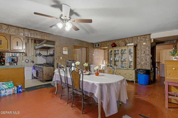 a view of a dining room with furniture and a chandelier fan
