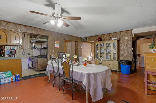 a view of a dining room with furniture and a chandelier fan