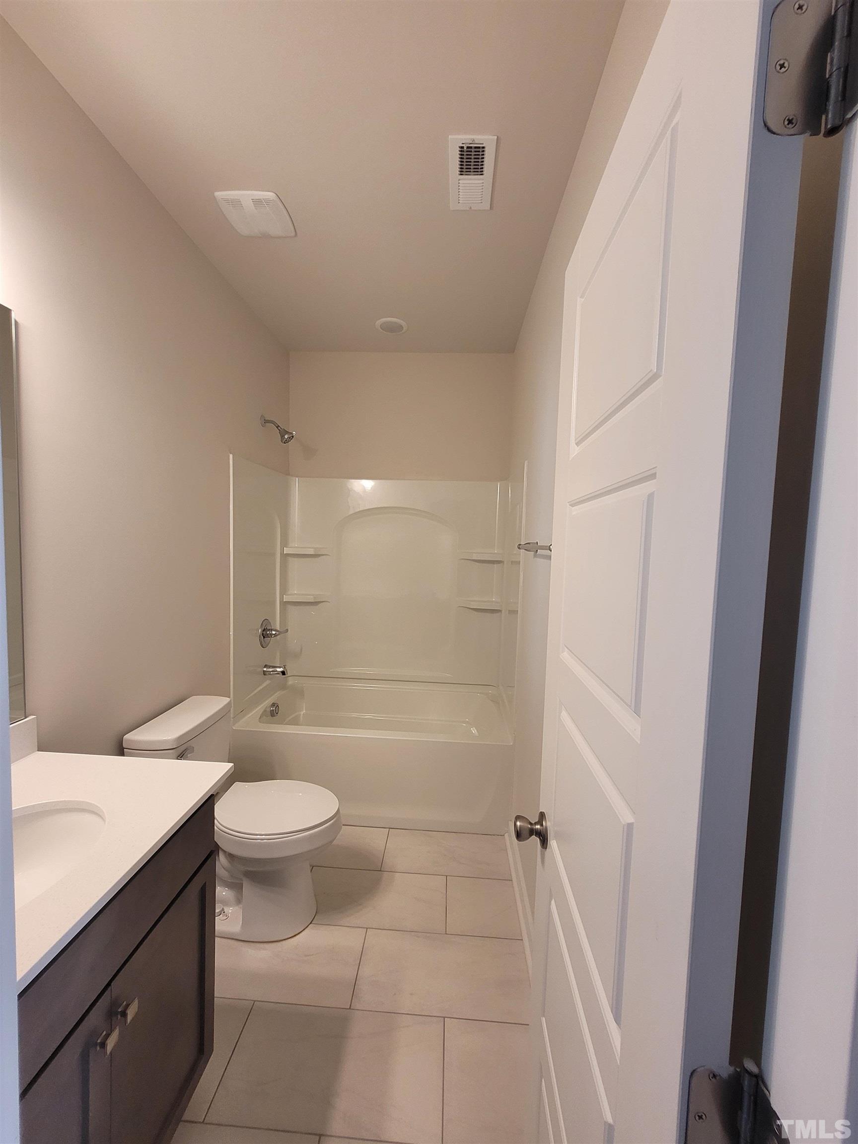 806 Laurel Gate Drive Wake Forest, NC 27587 - Photo 13 of 19 a bathroom with a granite countertop sink a toilet and shower