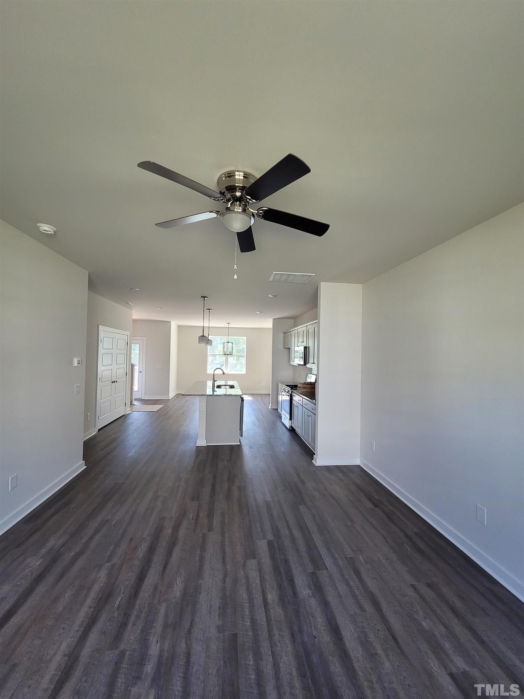 806 Laurel Gate Drive Wake Forest, NC 27587 - Photo 4 of 19 a view of a livingroom with wooden floor and a ceiling fan