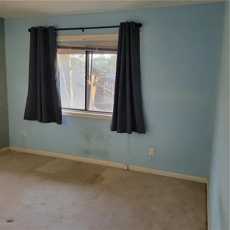 a bathroom with a window and a shower