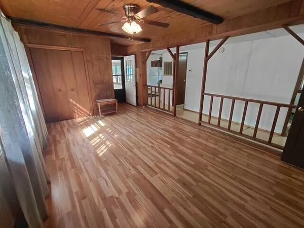 a view of an empty room with windows