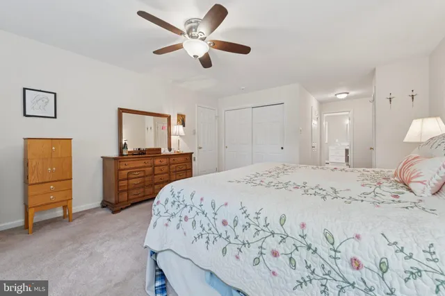 a spacious bedroom with a bed and a dresser