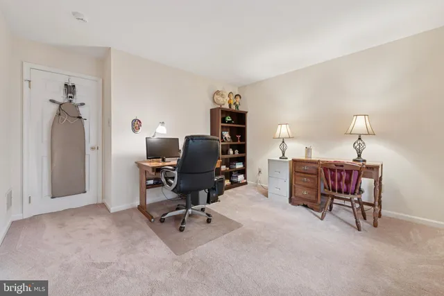 a view of a workspace with furniture and a bedroom
